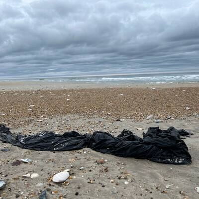 plastic tarp littering OBX beach