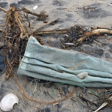 Covid mask left for trash on beach