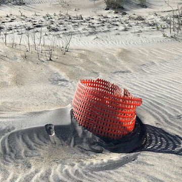 laundry basket discarded on beach